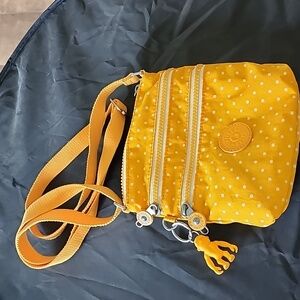 Well loved Kipling yellow mini crossbody purse‎ with gorilla charm